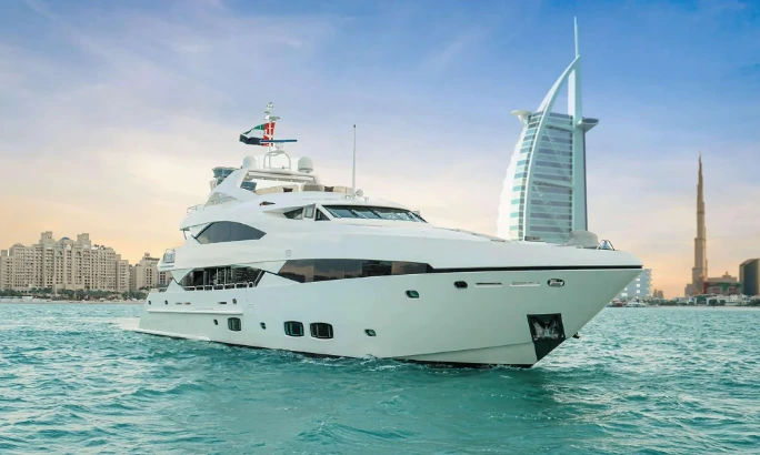 Private yacht sailing in Dubai of Al Qubtan near Palm Jumeirah during sunset